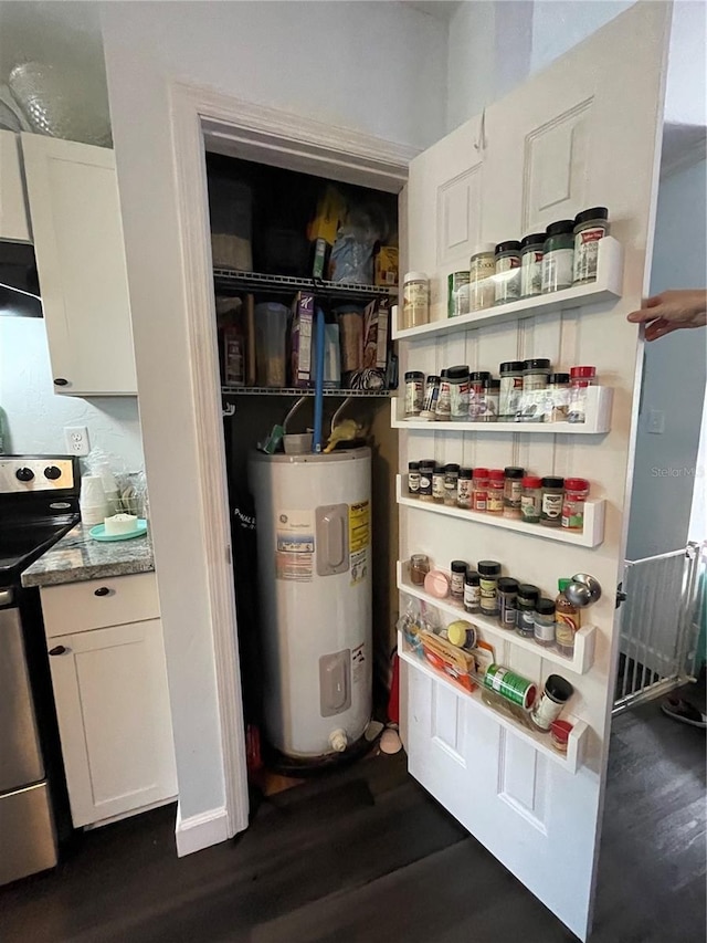 utility room featuring water heater