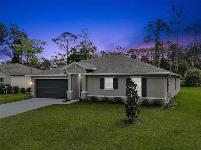 ranch-style home featuring a garage and a yard