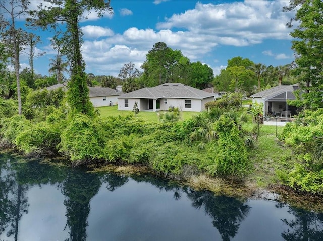 back of property featuring a water view