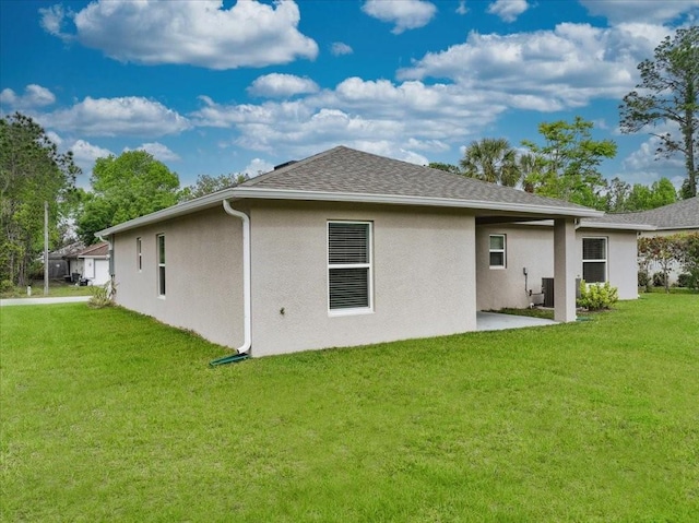 rear view of property featuring a lawn and a patio