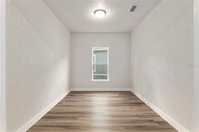 spare room with dark wood-type flooring