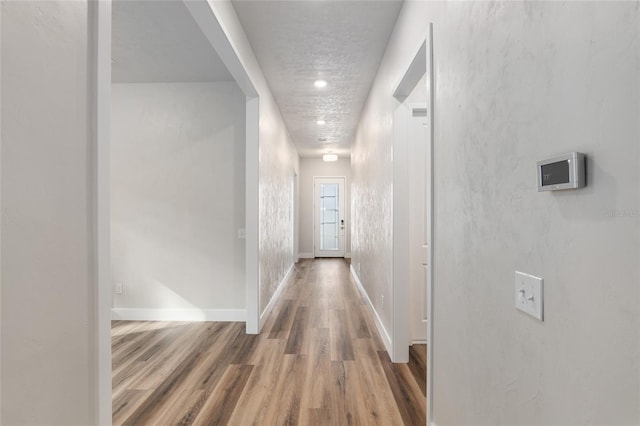 1023 NW 132nd Blvd, Newberry, FL 32669 - hallway featuring wood finished floors and baseboards