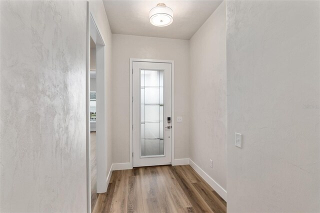 1023 NW 132nd Blvd, Newberry, FL 32669 - doorway featuring wood finished floors and baseboards