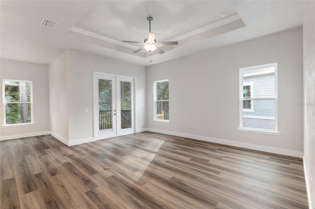 1023 NW 132nd Blvd, Newberry, FL 32669 - spare room featuring a tray ceiling, french doors, healthy amount of natural light, and baseboards