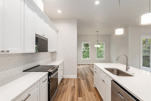 kitchen featuring appliances with stainless steel finishes and white cabinets