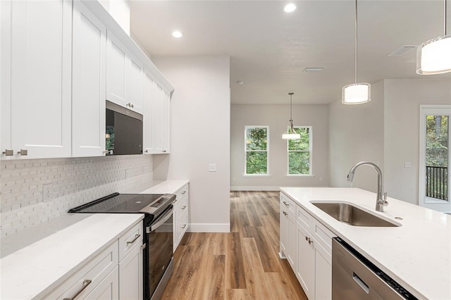 1023 NW 132nd Blvd, Newberry, FL 32669 - kitchen featuring electric range, a sink, light wood-style flooring, dishwasher, and tasteful backsplash