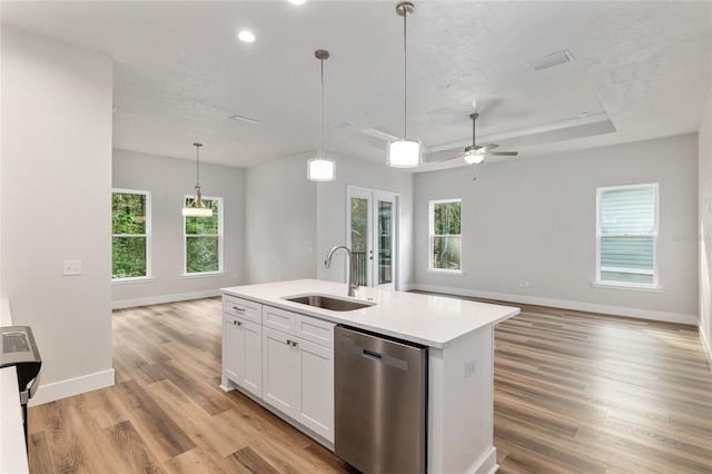 kitchen with appliances with stainless steel finishes, sink, an island with sink, a healthy amount of sunlight, and light hardwood / wood-style floors