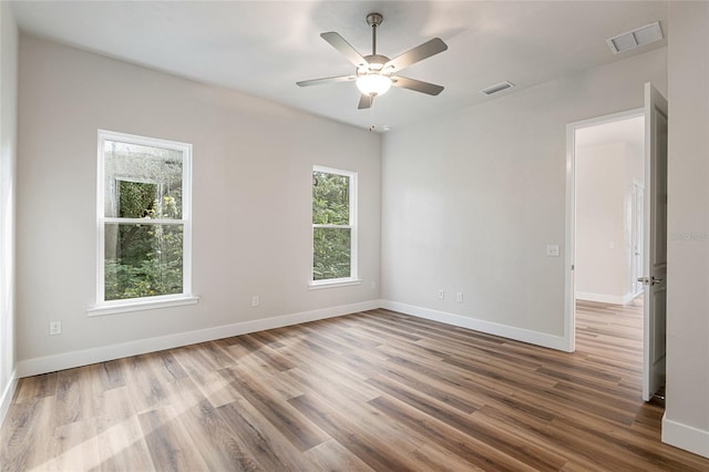 1023 NW 132nd Blvd, Newberry, FL 32669 - unfurnished room with wood finished floors, baseboards, and a ceiling fan