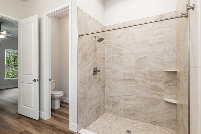 1023 NW 132nd Blvd, Newberry, FL 32669 - full bath featuring wood finished floors, toilet, a tile shower, and a ceiling fan
