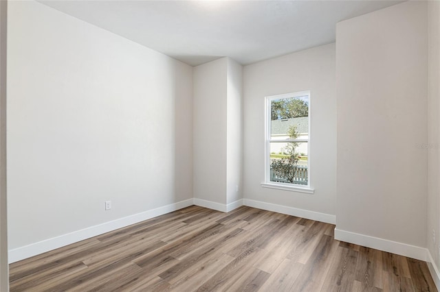 1023 NW 132nd Blvd, Newberry, FL 32669 - spare room featuring wood finished floors and baseboards