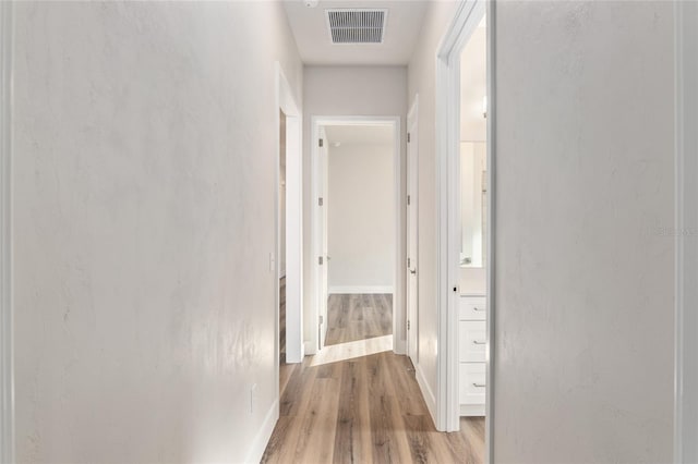 hall with light hardwood / wood-style floors