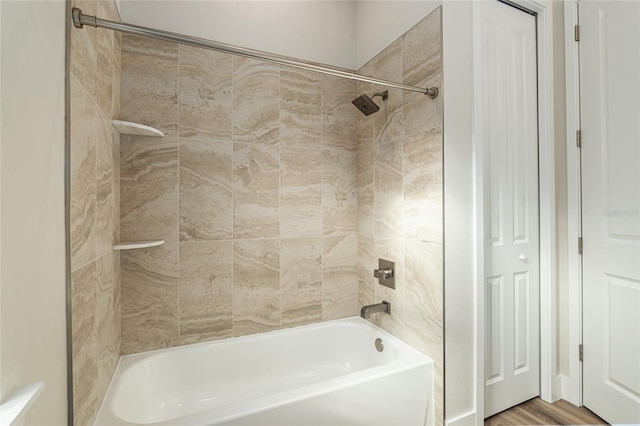 bathroom featuring tiled shower / bath and hardwood / wood-style flooring