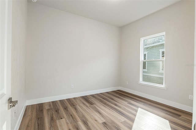 1023 NW 132nd Blvd, Newberry, FL 32669 - unfurnished room with wood finished floors and baseboards