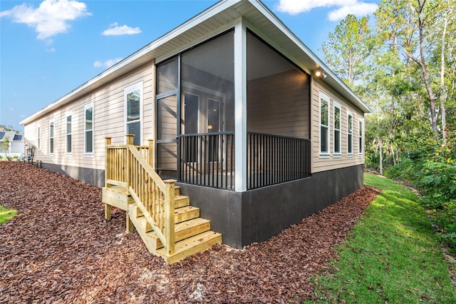 view of side of property featuring a sunroom