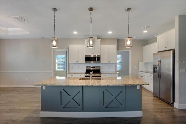 kitchen with a healthy amount of sunlight, pendant lighting, and appliances with stainless steel finishes