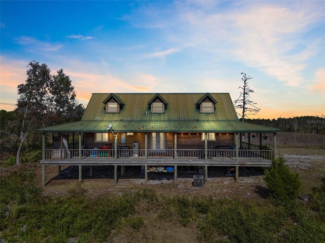7550 SW 127th Ct, Cedar Key, FL 32625 - view of front facade featuring cooling unit and metal roof