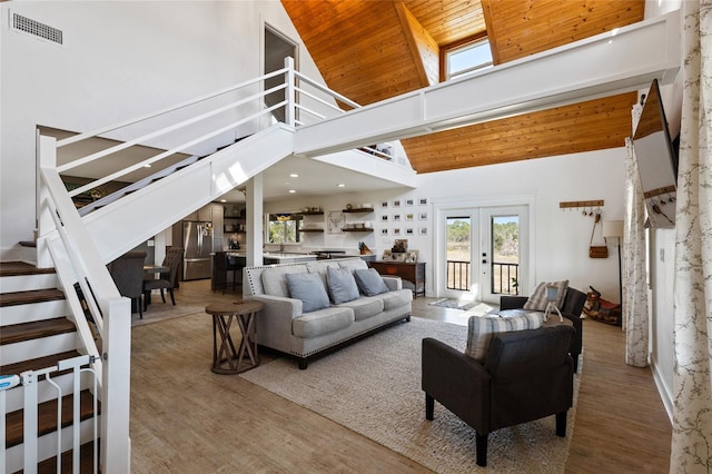 living room with hardwood / wood-style floors, high vaulted ceiling, wood ceiling, and french doors