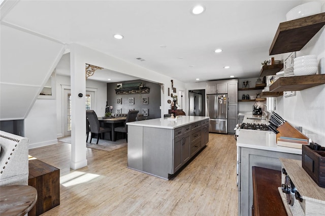 7550 SW 127th Ct, Cedar Key, FL 32625 - kitchen featuring open shelves, freestanding refrigerator, light countertops, light wood-type flooring, and recessed lighting