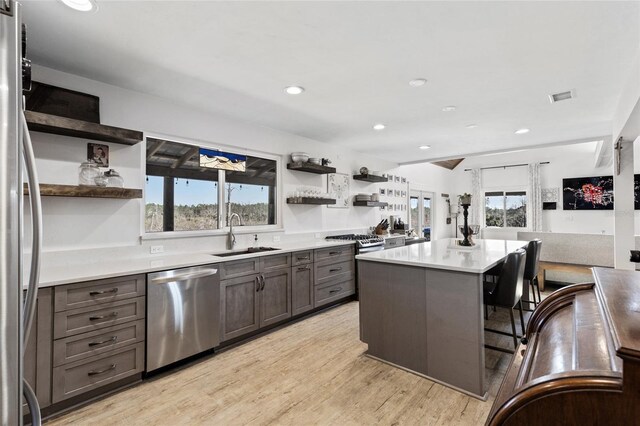 7550 SW 127th Ct, Cedar Key, FL 32625 - kitchen with stainless steel appliances, open shelves, a sink, plenty of natural light, and recessed lighting