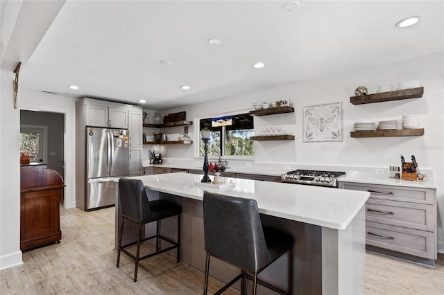 7550 SW 127th Ct, Cedar Key, FL 32625 - kitchen with open shelves, freestanding refrigerator, a kitchen island, a kitchen breakfast bar, and recessed lighting