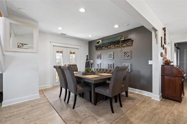 7550 SW 127th Ct, Cedar Key, FL 32625 - dining space with light wood-type flooring, baseboards, recessed lighting, and french doors