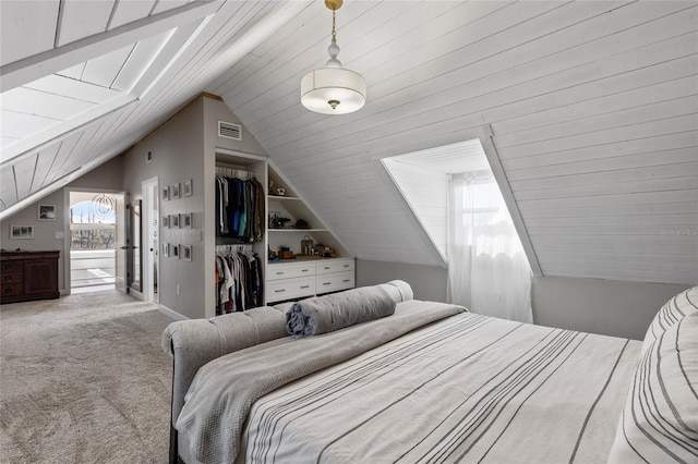 carpeted bedroom featuring lofted ceiling and a closet