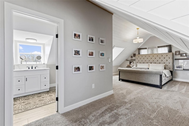 bedroom featuring light carpet, sink, and lofted ceiling