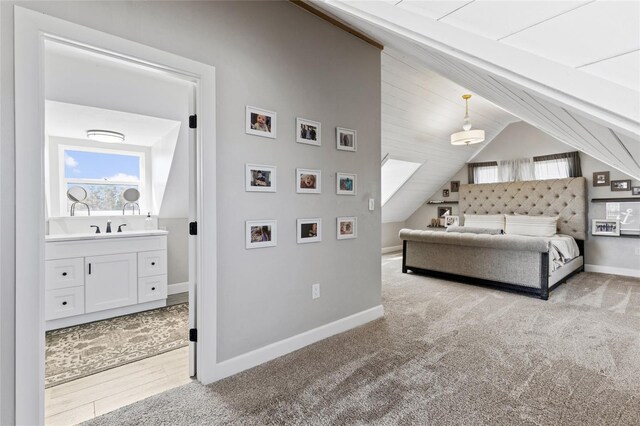 7550 SW 127th Ct, Cedar Key, FL 32625 - bedroom featuring vaulted ceiling, baseboards, a sink, carpet, and ensuite bath