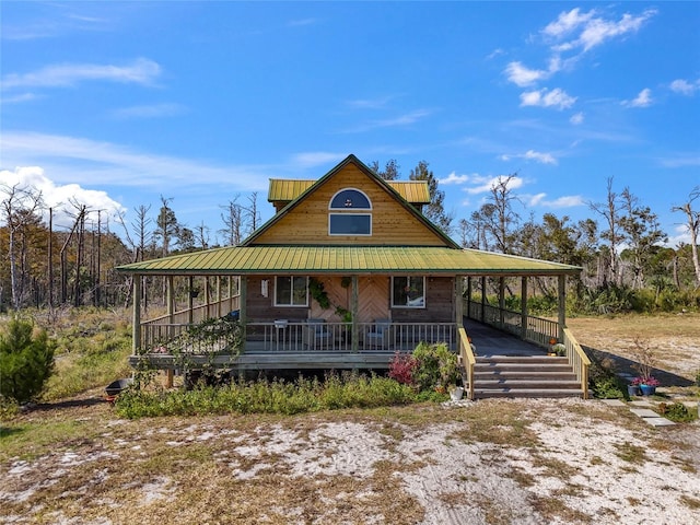 country-style home featuring covered porch