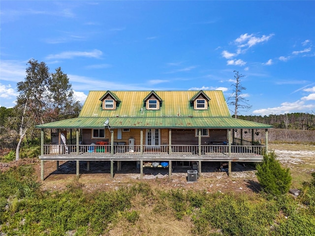 view of front of house with cooling unit and a porch