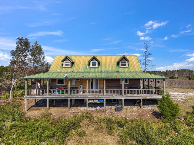 7550 SW 127th Ct, Cedar Key, FL 32625 - view of front of property featuring metal roof and cooling unit