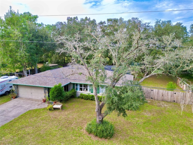 view of front of house featuring a garage and a front lawn