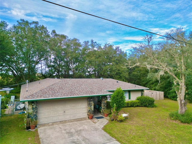 single story home featuring a front yard and a garage