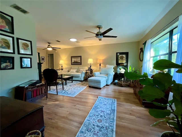 living room featuring ceiling fan and light hardwood / wood-style floors