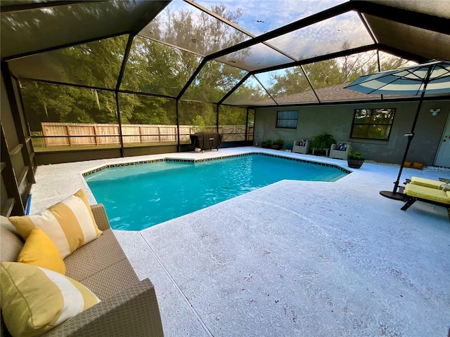 view of swimming pool featuring a lanai and a patio