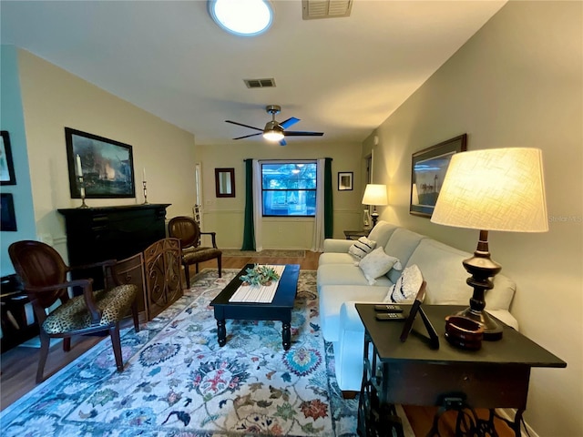 living room featuring hardwood / wood-style flooring and ceiling fan