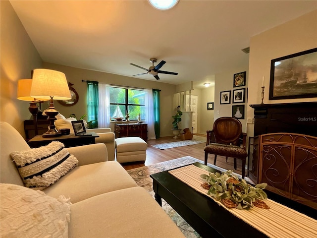 living room with wood-type flooring and ceiling fan