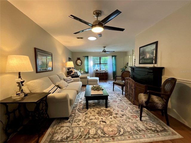 living room featuring ceiling fan and hardwood / wood-style flooring