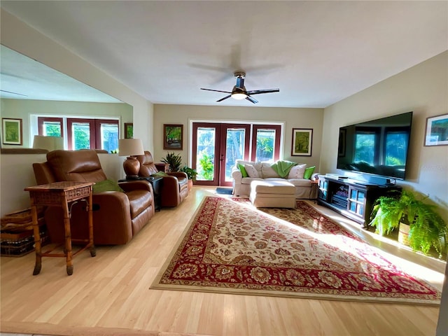 living room with ceiling fan, light hardwood / wood-style flooring, and french doors