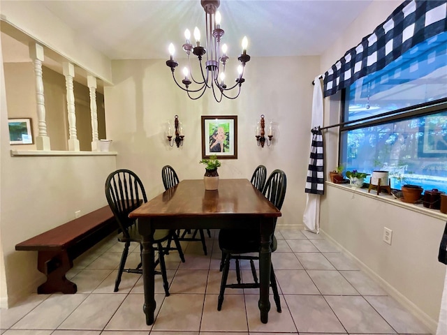 tiled dining space featuring a chandelier