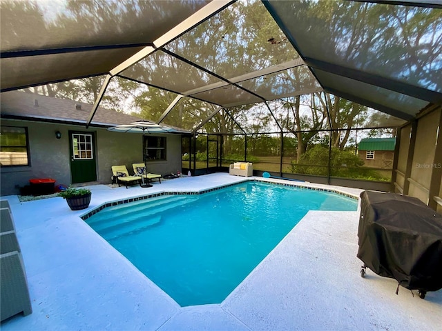 view of swimming pool with a lanai, grilling area, and a patio area