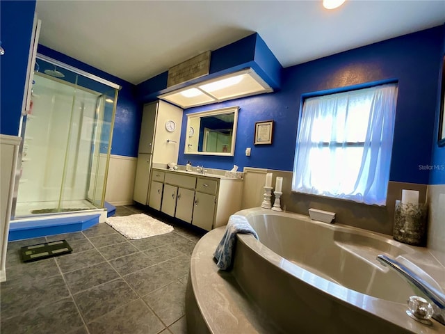 bathroom featuring tile patterned flooring, vanity, and separate shower and tub