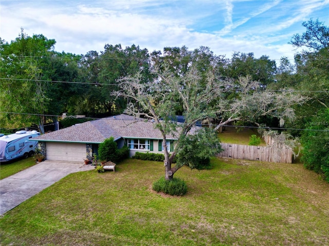 single story home with a front yard and a garage