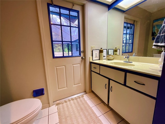 bathroom featuring tile patterned flooring, vanity, and toilet