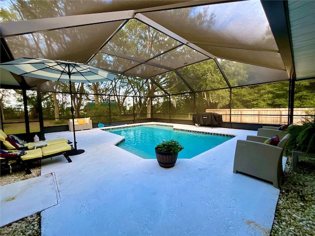 view of swimming pool with glass enclosure, a grill, and a patio