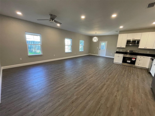 kitchen with ceiling fan, white cabinets, dark hardwood / wood-style floors, and appliances with stainless steel finishes