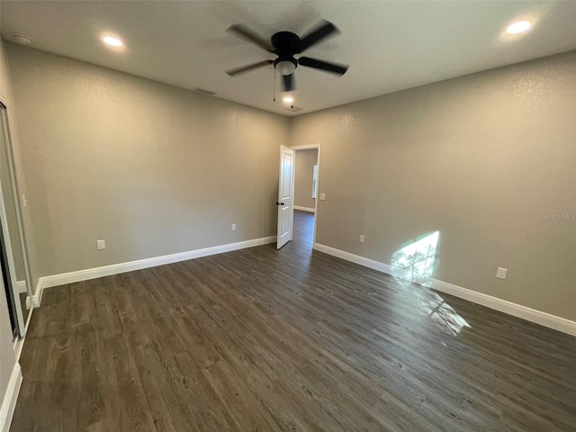 spare room featuring dark hardwood / wood-style floors and ceiling fan