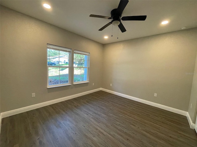 unfurnished room featuring ceiling fan and dark wood-type flooring