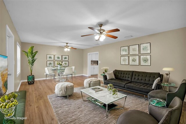 living room with hardwood / wood-style floors and ceiling fan