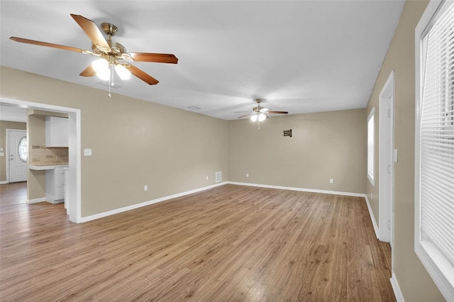 unfurnished room featuring ceiling fan and light wood-type flooring